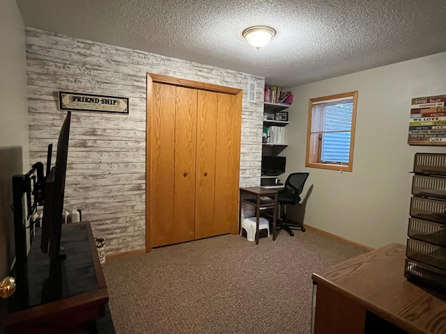 carpeted office with wooden walls and a textured ceiling