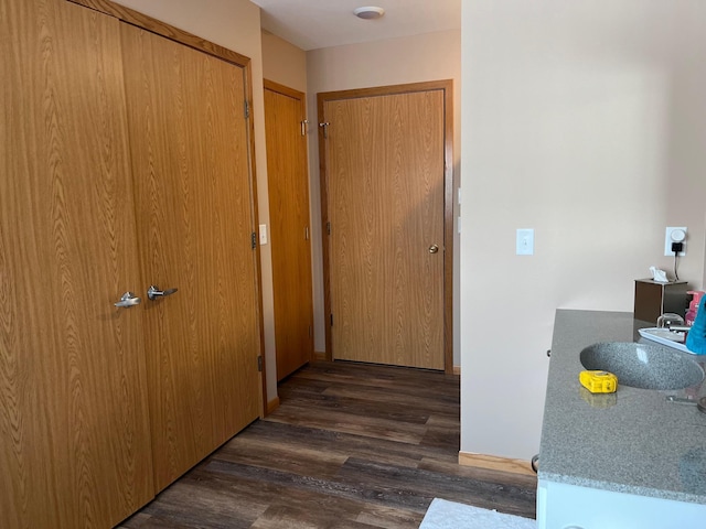 hallway with dark hardwood / wood-style flooring