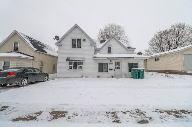 view of snow covered rear of property