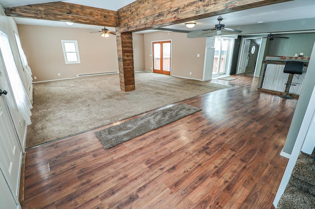 unfurnished living room with beam ceiling, a baseboard radiator, plenty of natural light, and dark hardwood / wood-style flooring