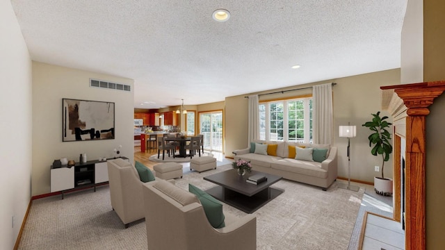 living room with light colored carpet and a textured ceiling