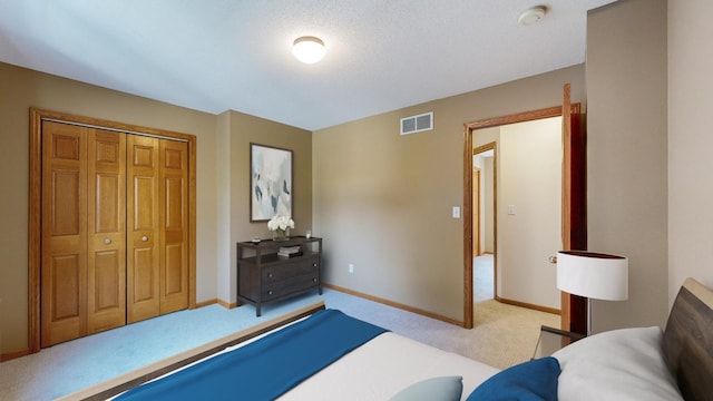 bedroom featuring light colored carpet and a closet