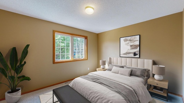 bedroom featuring light carpet and a textured ceiling