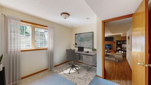 office area with a textured ceiling