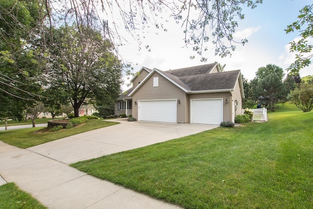 view of front of house with a garage and a front lawn