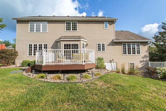 back of house featuring a yard and a deck