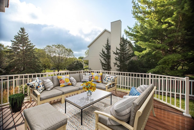 wooden deck with an outdoor living space