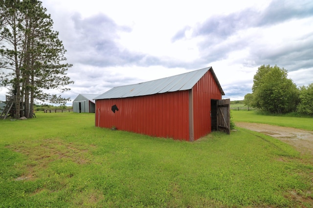 view of outbuilding featuring a lawn