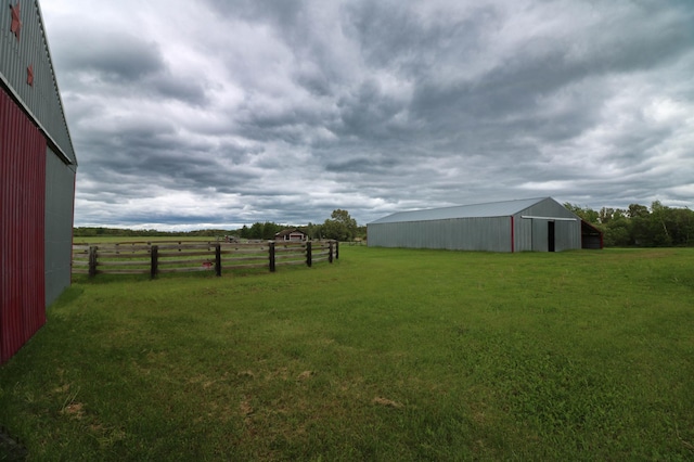 view of yard featuring a rural view and an outdoor structure