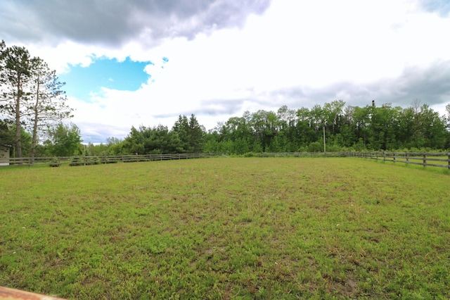 view of yard with a rural view