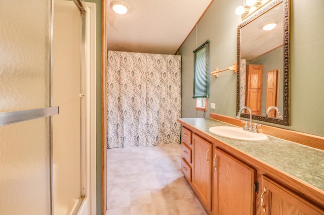 bathroom with vanity, a textured ceiling, and a shower with shower curtain