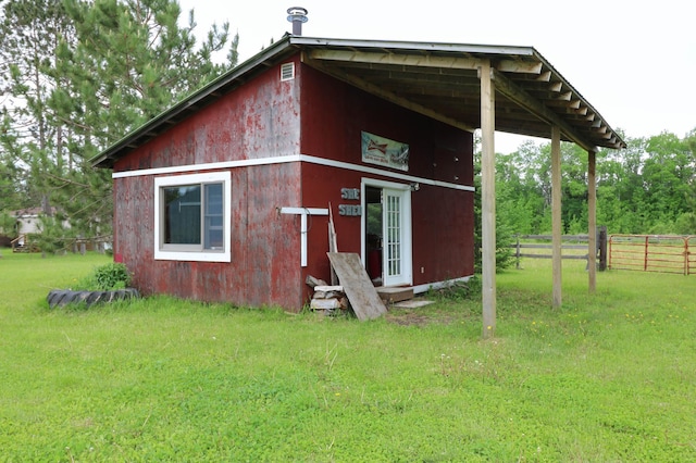 view of outbuilding featuring a lawn