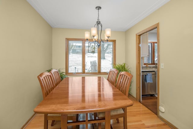 dining room with a chandelier and light wood-type flooring