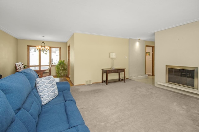 living room with ornamental molding, carpet floors, and a notable chandelier