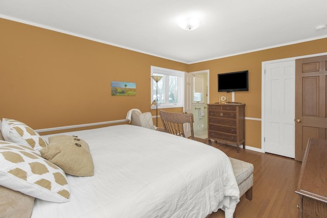 bedroom featuring crown molding and wood-type flooring