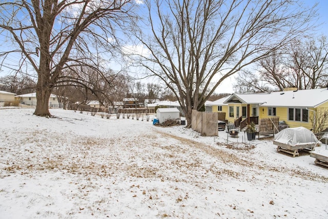 yard layered in snow featuring a deck