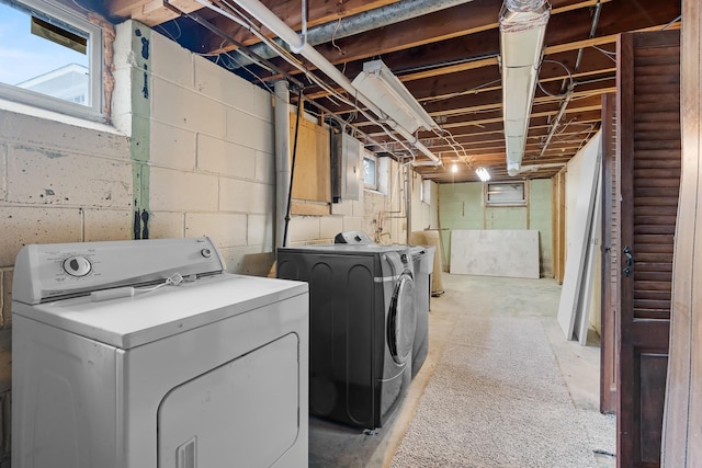 laundry area featuring washing machine and clothes dryer and electric panel