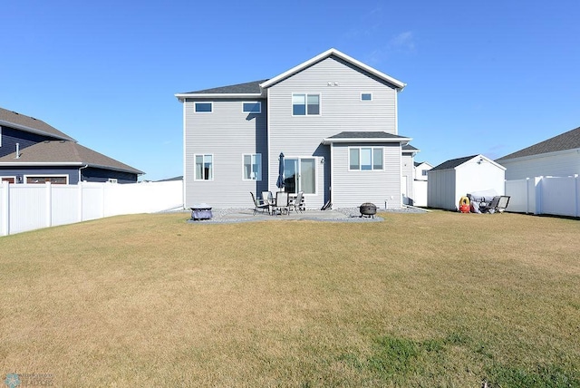 back of property featuring a storage shed, a patio, and a lawn