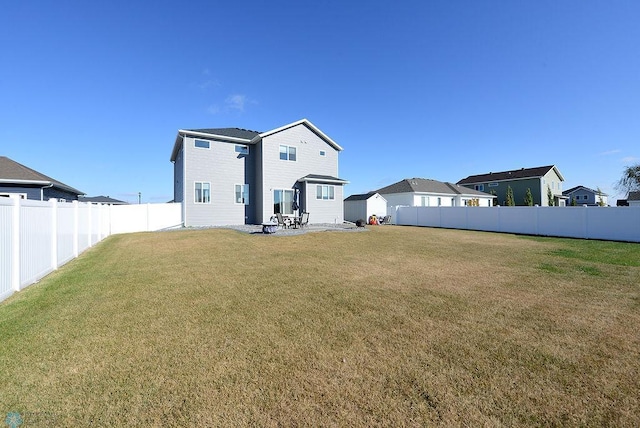 back of house featuring a patio and a lawn