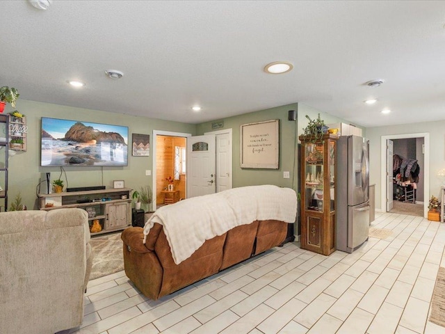 bedroom featuring stainless steel fridge with ice dispenser and a closet