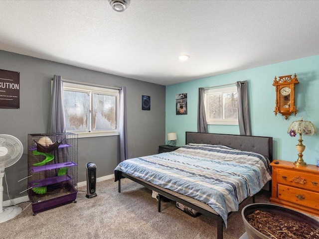 bedroom featuring light colored carpet and a textured ceiling