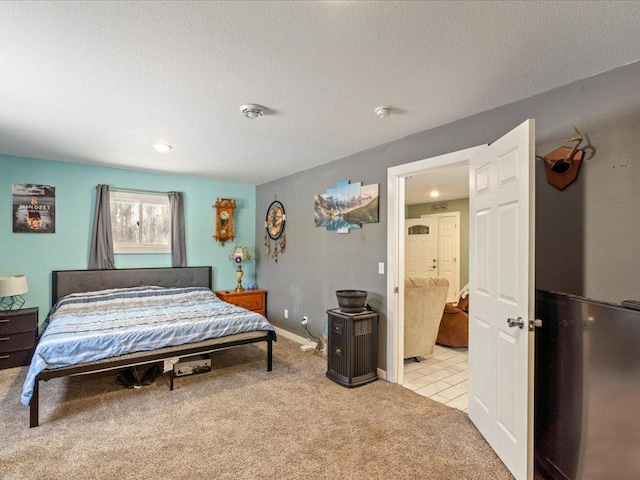 bedroom featuring light colored carpet and a textured ceiling