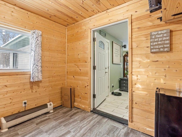 interior space with hardwood / wood-style floors, wood ceiling, and wood walls