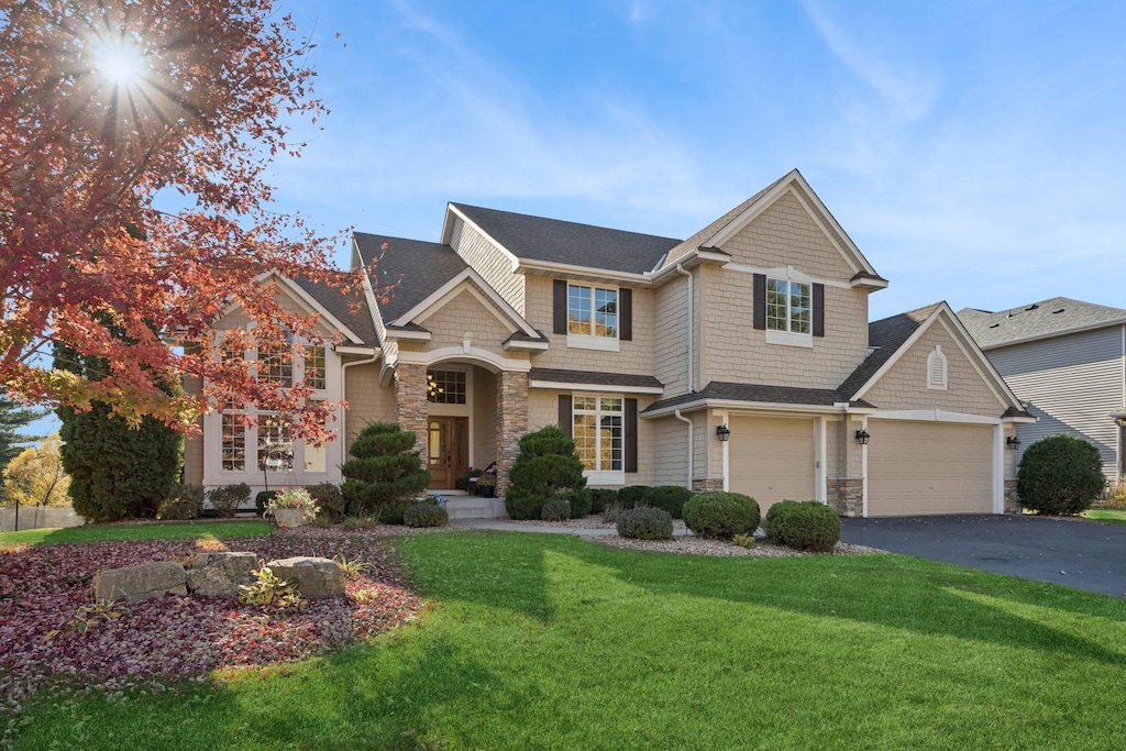 craftsman-style home with a garage and a front yard