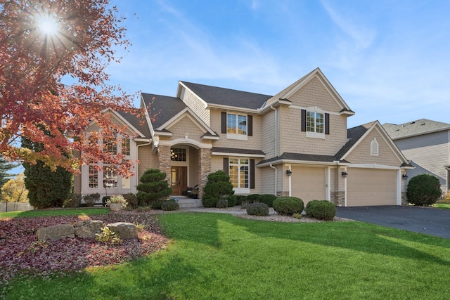 craftsman-style home with a garage and a front yard