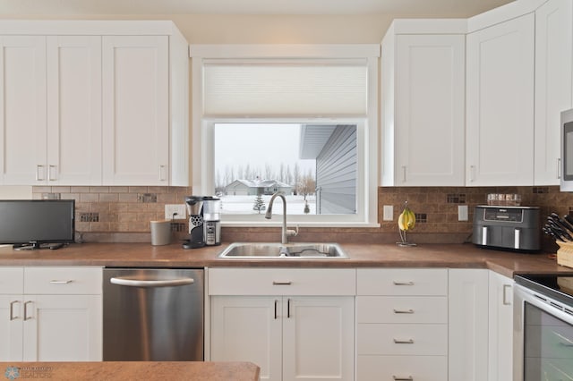 kitchen featuring white cabinetry, sink, and appliances with stainless steel finishes