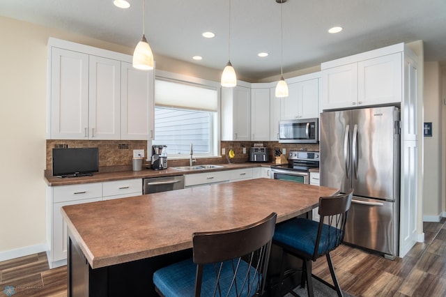 kitchen featuring white cabinetry, a center island, and appliances with stainless steel finishes