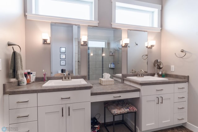 bathroom featuring vanity and tiled shower