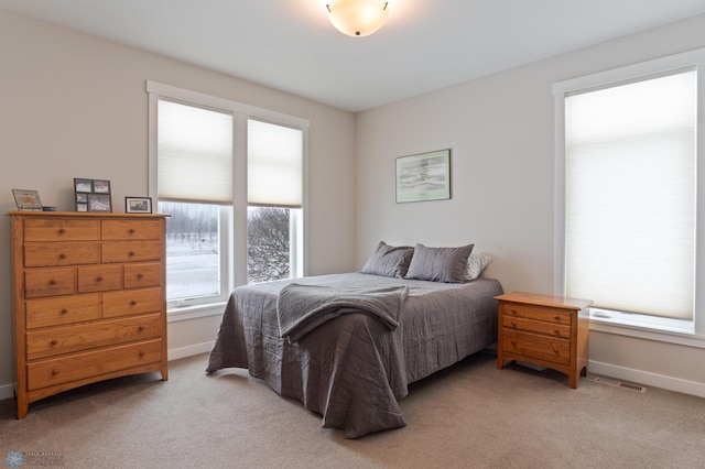 bedroom with light colored carpet