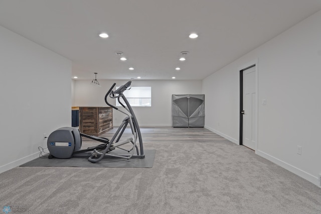 exercise room featuring light colored carpet