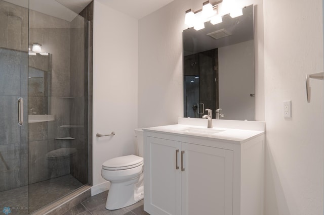 bathroom featuring vanity, a shower with shower door, and toilet