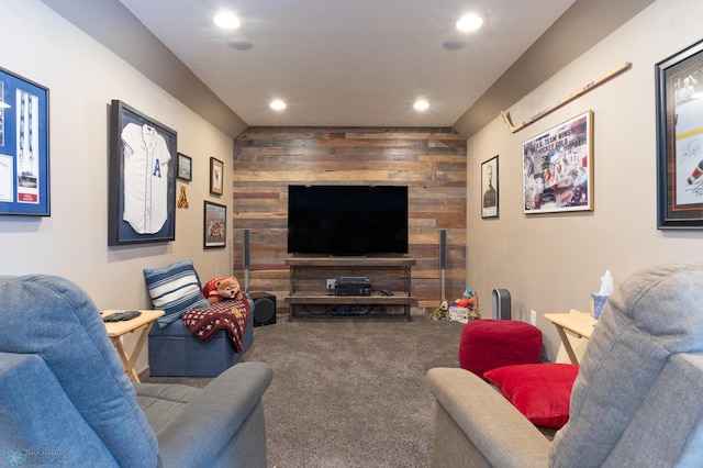 carpeted living room with wood walls