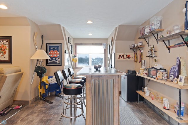 kitchen featuring dark hardwood / wood-style floors and a breakfast bar area