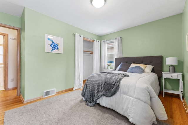 bedroom featuring wood-type flooring and a closet