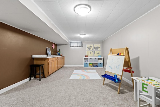 playroom with light carpet and ornamental molding