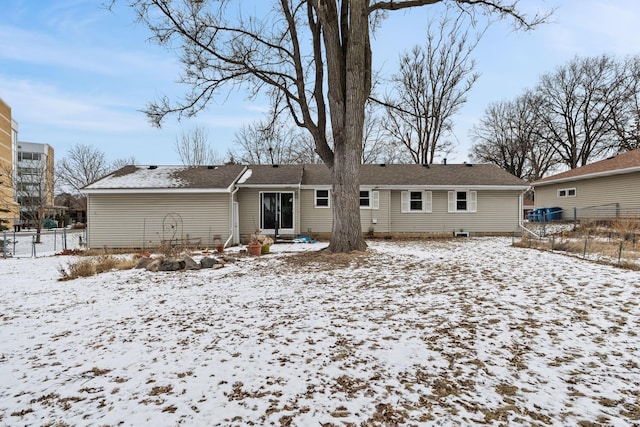 view of snow covered rear of property