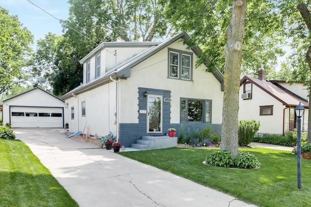 view of front facade featuring a garage, an outdoor structure, and a front lawn