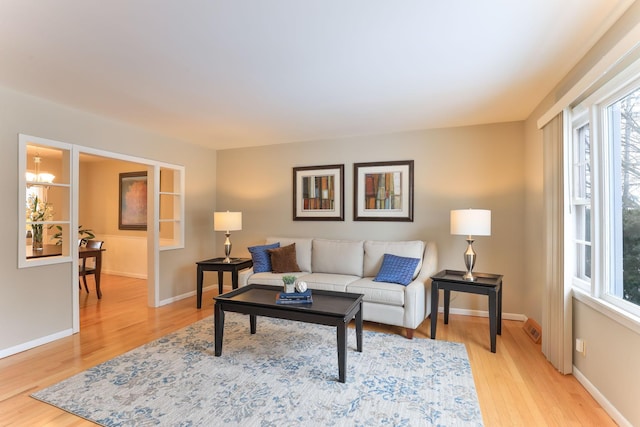 living room with hardwood / wood-style floors and a chandelier