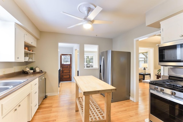 kitchen with white cabinetry, light hardwood / wood-style flooring, and appliances with stainless steel finishes