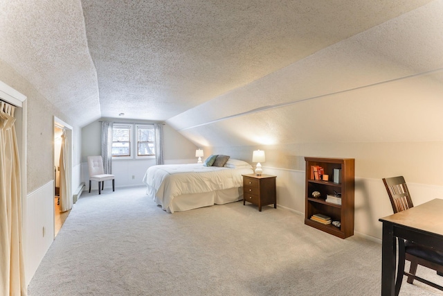 bedroom with lofted ceiling, light carpet, and a textured ceiling