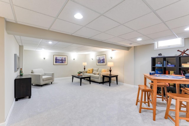 carpeted living room with a drop ceiling