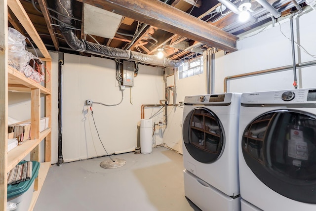 clothes washing area with washing machine and clothes dryer and electric panel