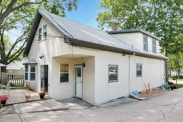 rear view of house featuring a deck