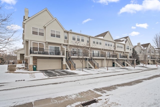 snow covered building with a garage