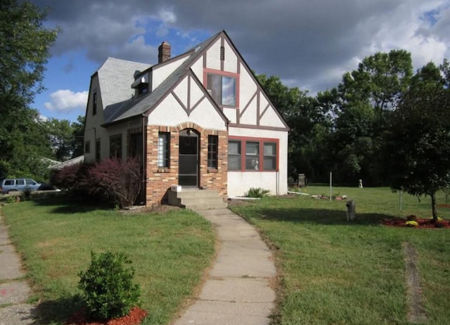 5801 23rd Ave S, Minneapolis, MN 55417 - tudor home with a front lawn, stucco siding, a chimney, and brick siding