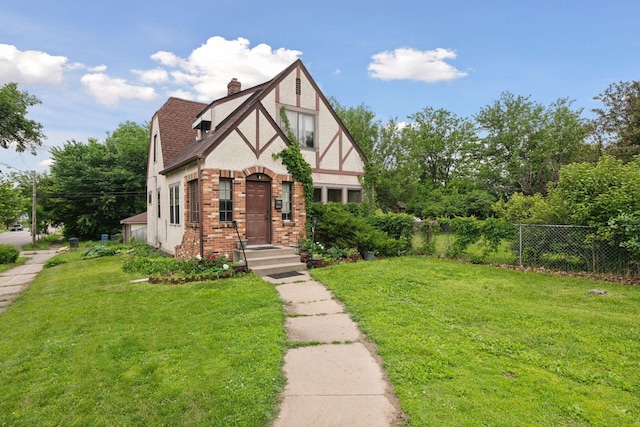 5801 23rd Ave S, Minneapolis, MN 55417 - english style home with brick siding, a chimney, stucco siding, and roof with shingles